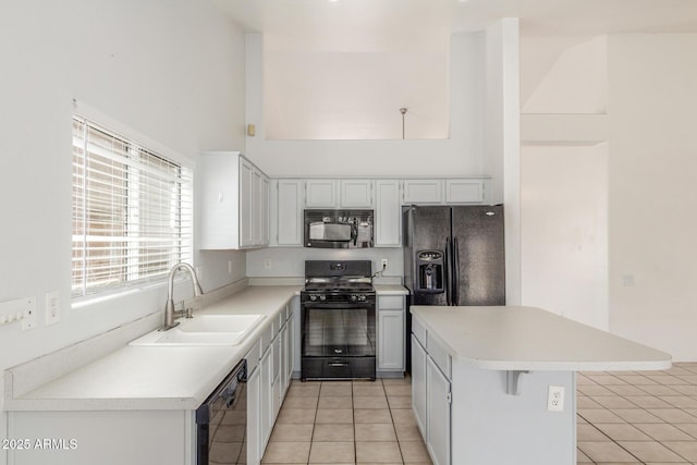 1371 W Gary Dr, Chandler, AZ 85224 - kitchen with black appliances, a towering ceiling, light tile patterned floors, a kitchen island, and light countertops