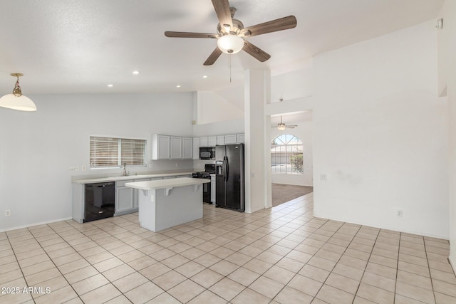 1371 W Gary Dr, Chandler, AZ 85224 - kitchen with black appliances, light countertops, ceiling fan, high vaulted ceiling, and a center island