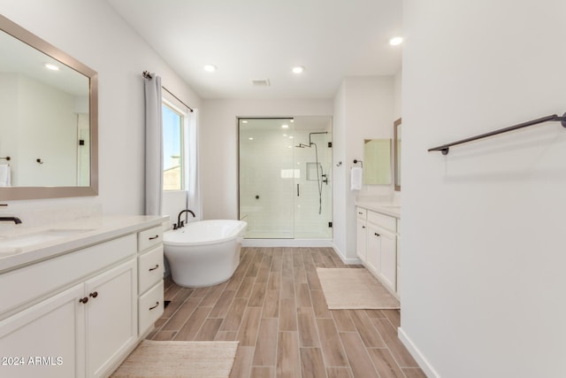 bathroom with vanity and separate shower and tub