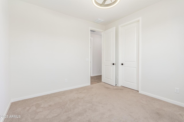 unfurnished bedroom featuring light carpet