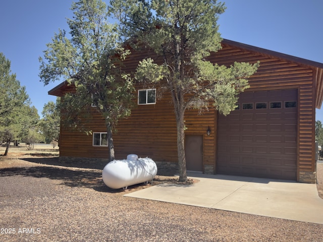 2273 Lindbergh Rd, Overgaard, AZ 85933 - view of side of home with a garage and concrete driveway