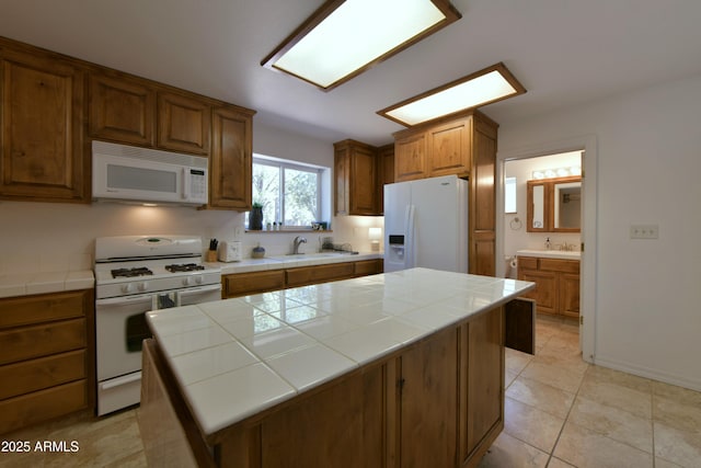 2273 Lindbergh Rd, Overgaard, AZ 85933 - kitchen featuring white appliances, tile countertops, a center island, and a sink