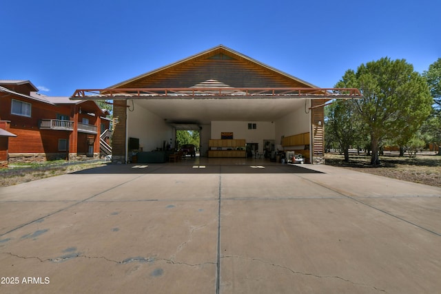 2273 Lindbergh Rd, Overgaard, AZ 85933 - view of front of house with concrete driveway, stone siding, stucco siding, and stairway