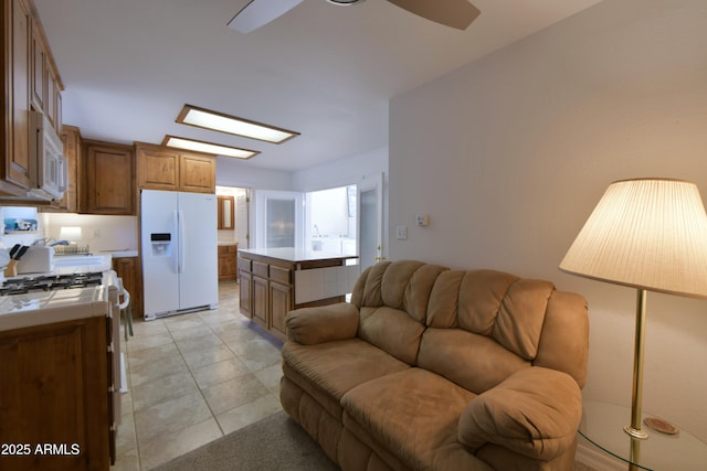 2273 Lindbergh Rd, Overgaard, AZ 85933 - kitchen featuring white appliances, tile counters, open floor plan, a ceiling fan, and brown cabinets