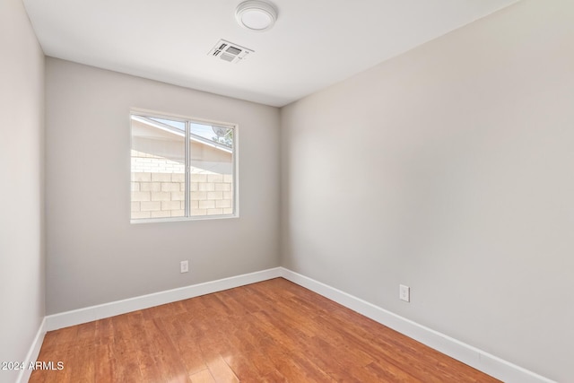 unfurnished room featuring hardwood / wood-style flooring