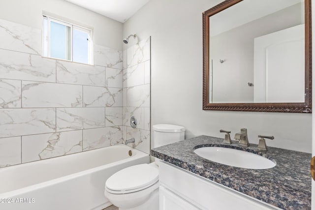 full bathroom featuring toilet, vanity, and tiled shower / bath