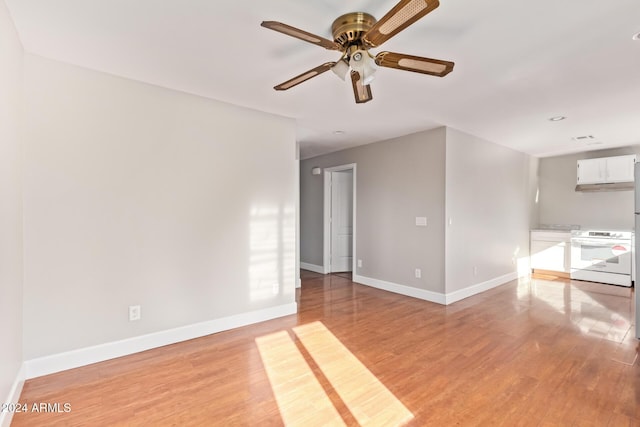 unfurnished room with ceiling fan and light hardwood / wood-style flooring