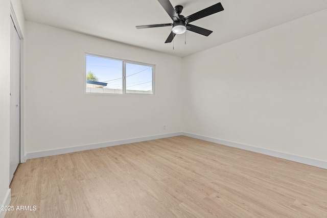 unfurnished bedroom with a closet, baseboards, and light wood-style floors