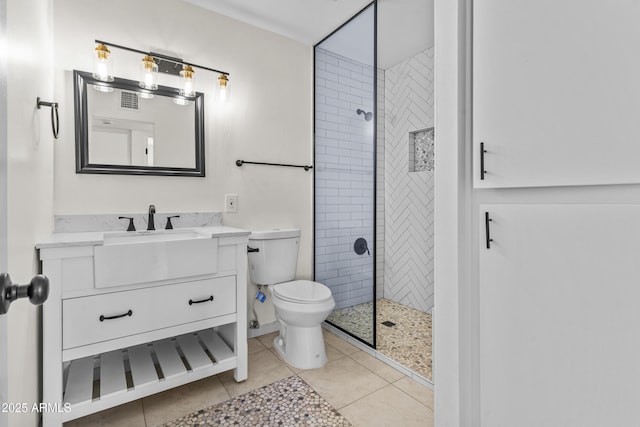 full bathroom with vanity, visible vents, tiled shower, tile patterned floors, and toilet