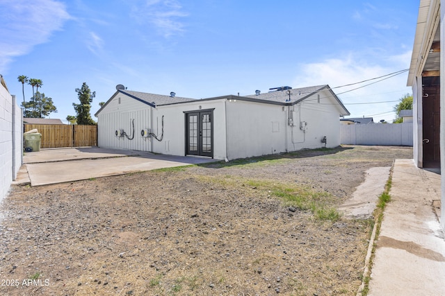 rear view of property featuring french doors, a fenced backyard, and a patio area