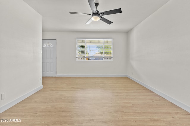 unfurnished room featuring baseboards, a ceiling fan, and wood finished floors
