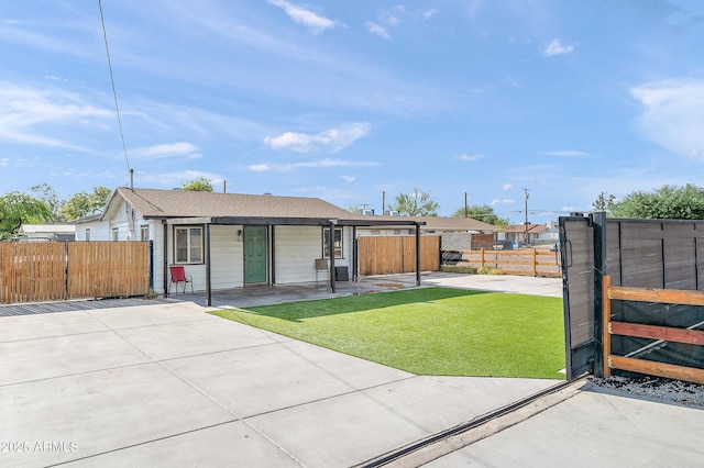 view of front of property featuring a gate, fence, and a front lawn