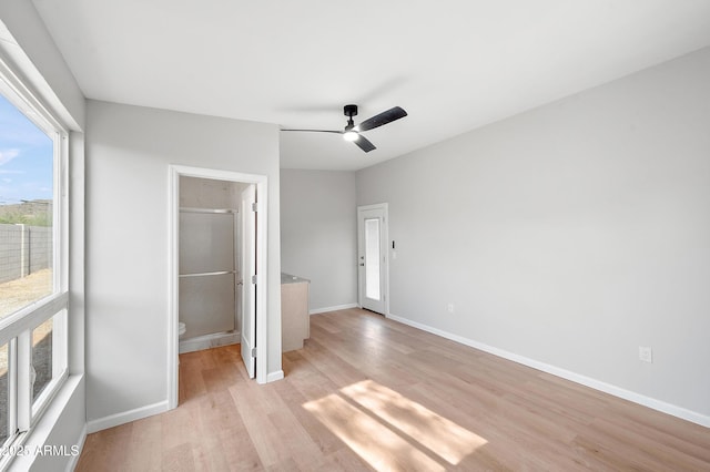unfurnished bedroom featuring a ceiling fan, baseboards, and light wood-style floors