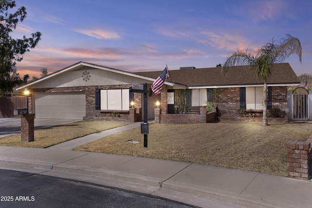 single story home featuring a garage, brick siding, a shingled roof, driveway, and a gate