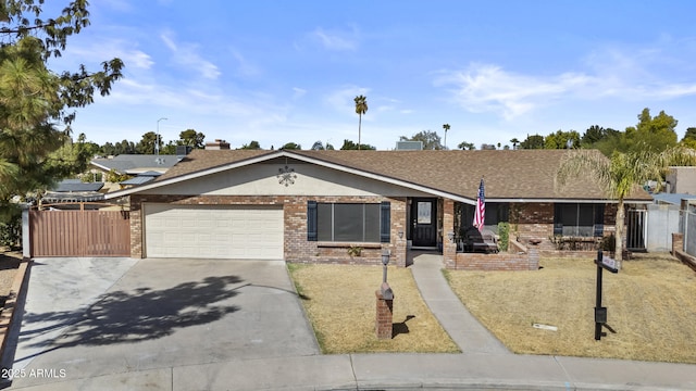 ranch-style home with an attached garage, brick siding, fence, driveway, and roof with shingles