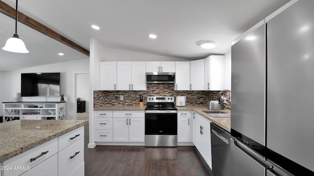 kitchen with light stone countertops, stainless steel appliances, lofted ceiling with beams, decorative light fixtures, and white cabinets