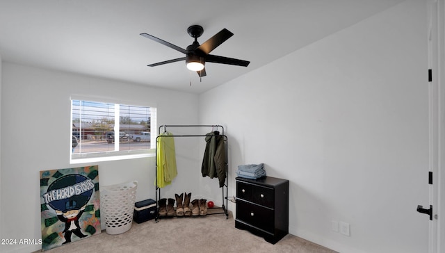 interior space with light carpet and ceiling fan