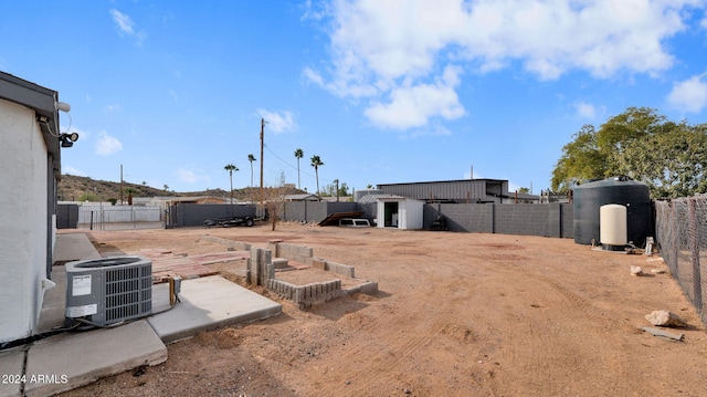 view of yard with central AC and a storage shed