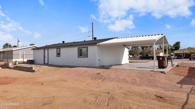 back of house with central AC unit