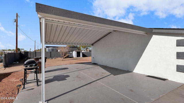 view of patio / terrace featuring a shed and grilling area