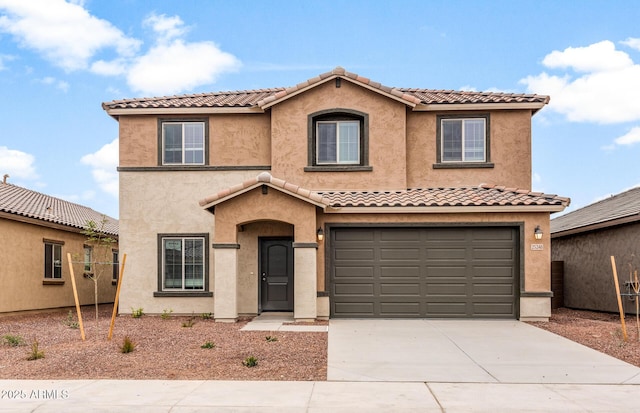 mediterranean / spanish-style home with a garage