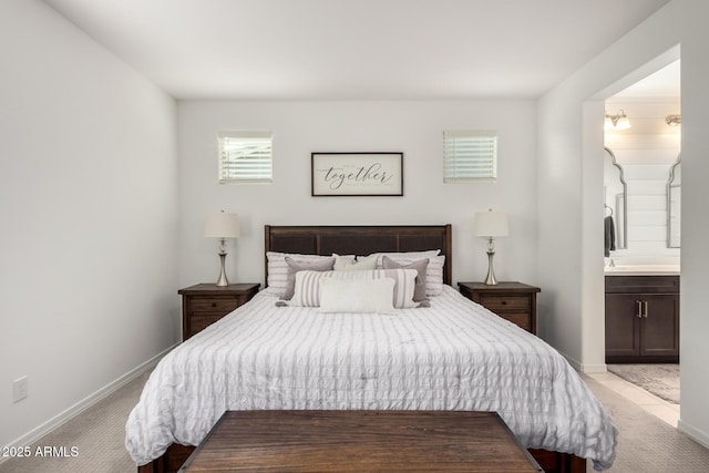 bedroom featuring carpet floors, baseboards, and ensuite bathroom