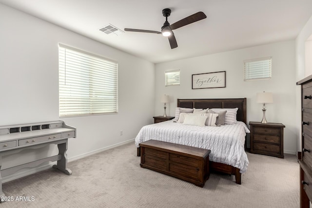 carpeted bedroom with baseboards, visible vents, and a ceiling fan