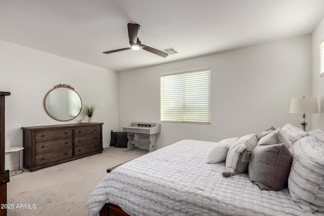 bedroom featuring a ceiling fan, carpet flooring, visible vents, and multiple windows