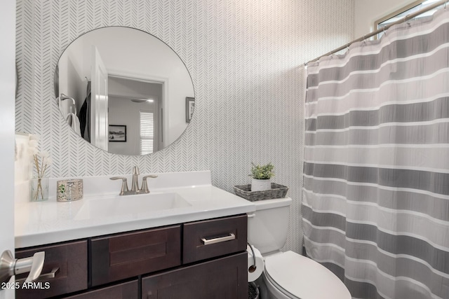 bathroom featuring backsplash, vanity, toilet, and tile walls