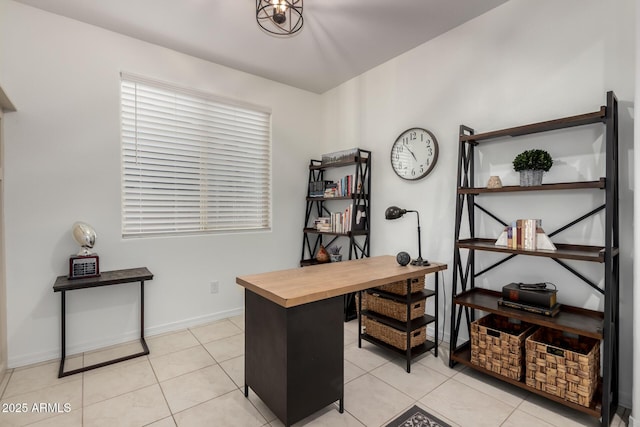 home office featuring light tile patterned floors and baseboards