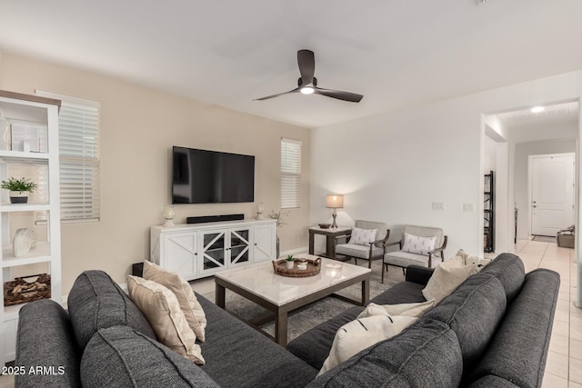 living area featuring light tile patterned flooring and ceiling fan