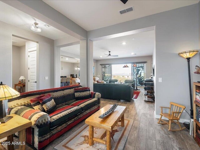 living room with ceiling fan and wood-type flooring