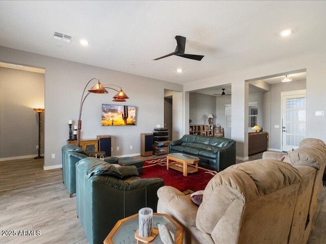 living room with ceiling fan and light wood-type flooring