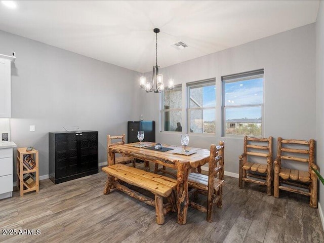 dining room featuring an inviting chandelier and hardwood / wood-style floors