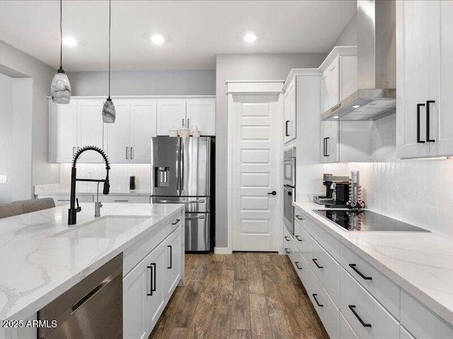 kitchen featuring white cabinetry, sink, stainless steel appliances, and wall chimney exhaust hood