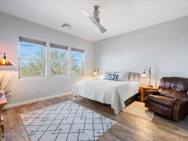 bedroom with hardwood / wood-style flooring and ceiling fan