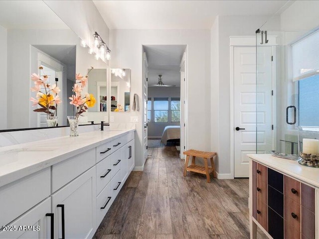 bathroom featuring vanity, hardwood / wood-style floors, and walk in shower