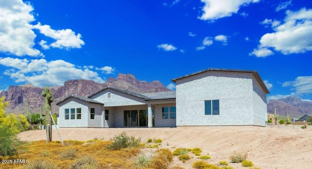 back of house with a mountain view