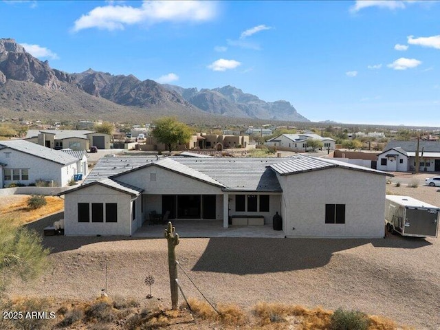 rear view of property featuring a mountain view and a patio