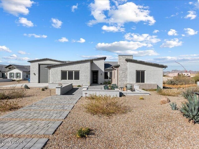 back of property featuring a garage