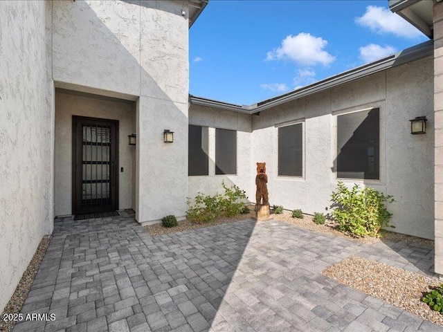 property entrance featuring a patio area