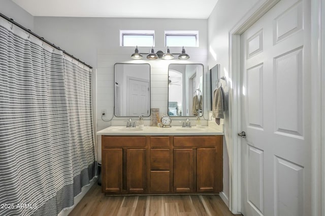 18841 E Pelican Ct, Queen Creek, AZ 85142 - bathroom featuring double vanity, a shower with curtain, wood finished floors, and a sink