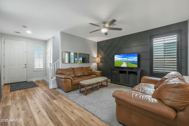 18841 E Pelican Ct, Queen Creek, AZ 85142 - living area with light wood finished floors, visible vents, ceiling fan, baseboards, and stairs