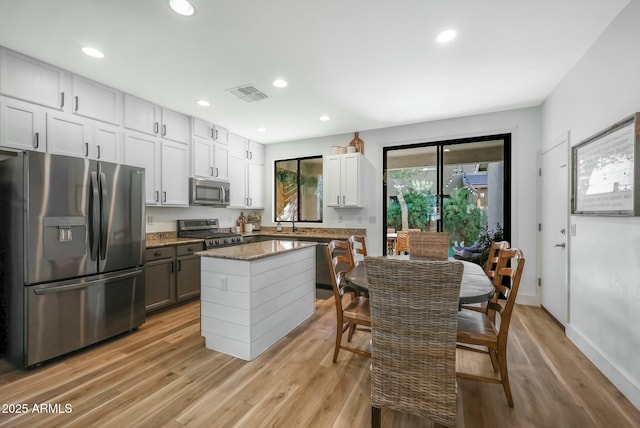 18841 E Pelican Ct, Queen Creek, AZ 85142 - kitchen with light wood-type flooring, recessed lighting, visible vents, and stainless steel appliances