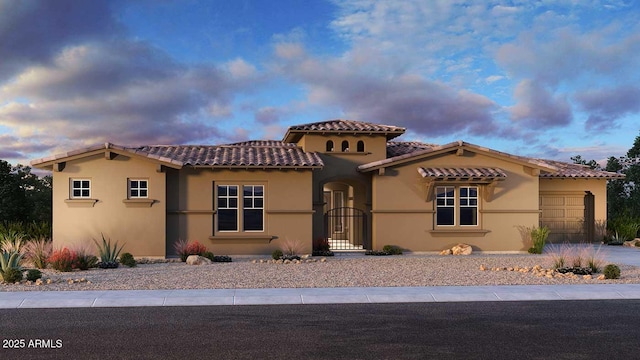 13382 E Sand Hills Rd, Scottsdale, AZ 85255 - mediterranean / spanish-style home featuring stucco siding, an attached garage, a tiled roof, a gate, and driveway