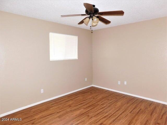 spare room with wood-type flooring, a textured ceiling, and ceiling fan