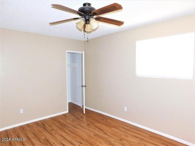 spare room featuring ceiling fan and hardwood / wood-style flooring