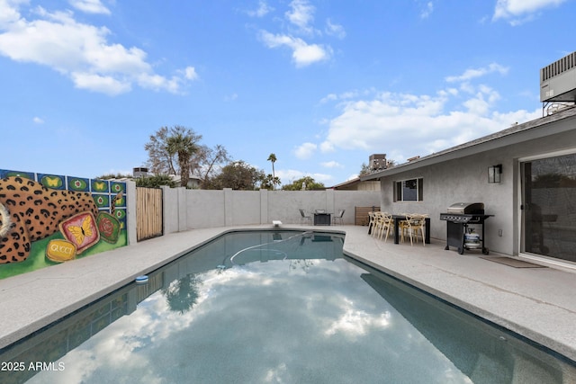 view of pool featuring a patio area, a fenced in pool, a fenced backyard, and a grill