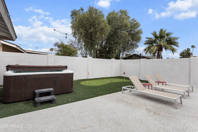 view of patio with a hot tub and a fenced backyard