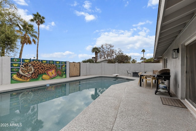view of pool featuring a fenced backyard, grilling area, a diving board, a patio, and a fenced in pool